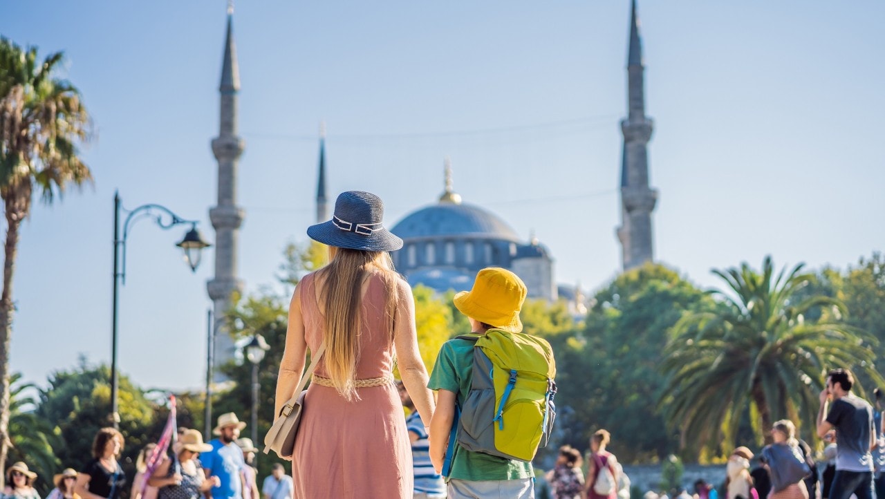 Mother and son tourists enjoying the view Blue Mosque Sultanahmet Camii Istanbul, Turkey. Traveling with kids concept.