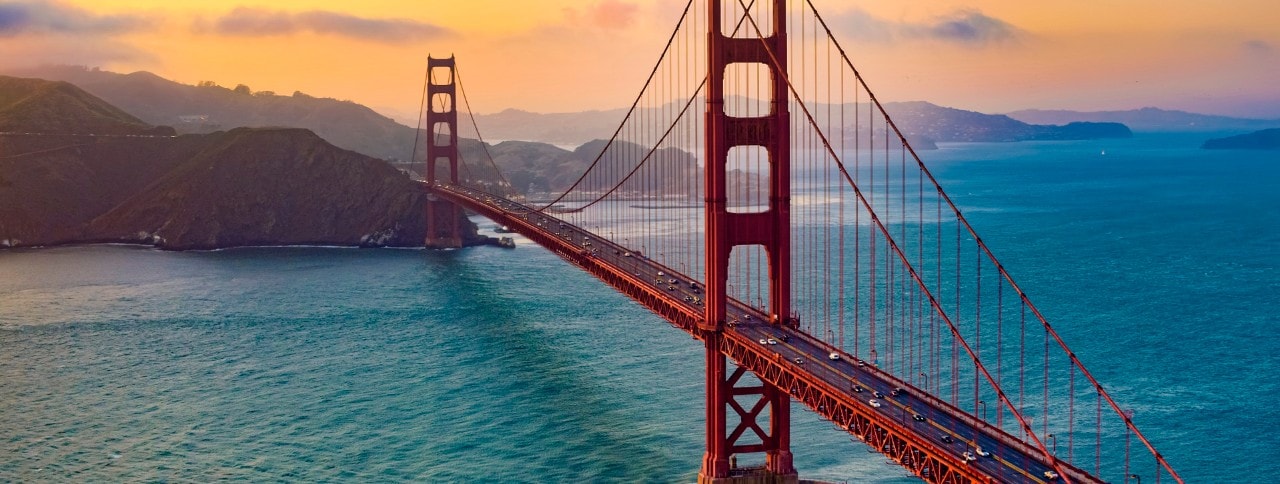 Aerial view of traffic moving on Golden Gate Bridge during sunset, San Francisco, California, USA.