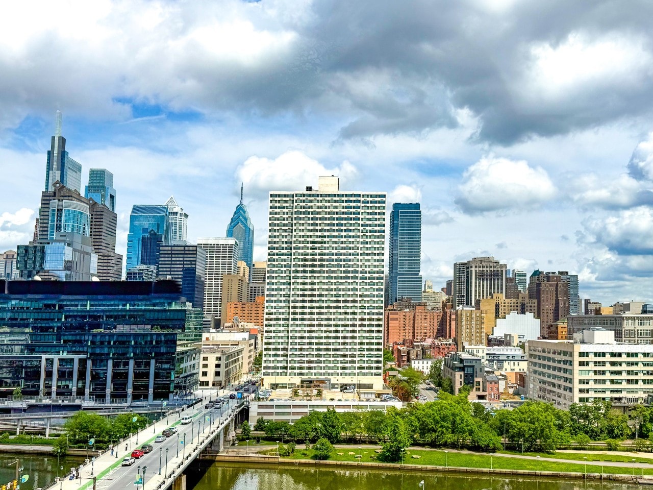Looking east towards the office buildings of Center City, seen from West Philadelphia's Cira Green, Philadelphia, Pennsylvania, USA - June 10, 2025.  Cera Green is an urban green space featuring grassy spots, skyline vistas, a burger joint & outdoor activities.